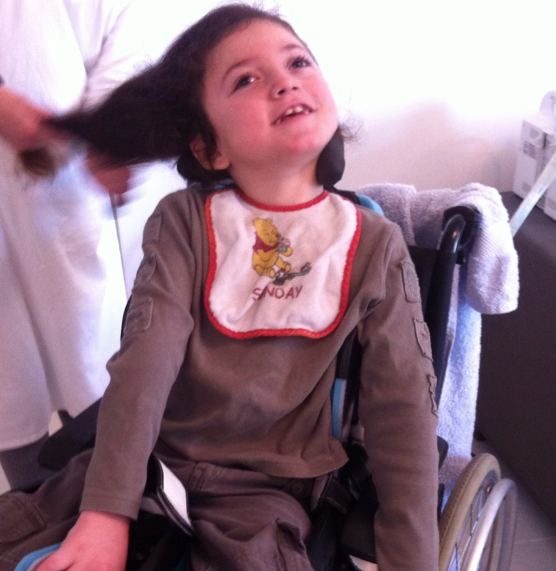 Shmouel in his chair, his gaze turned toward the light.
